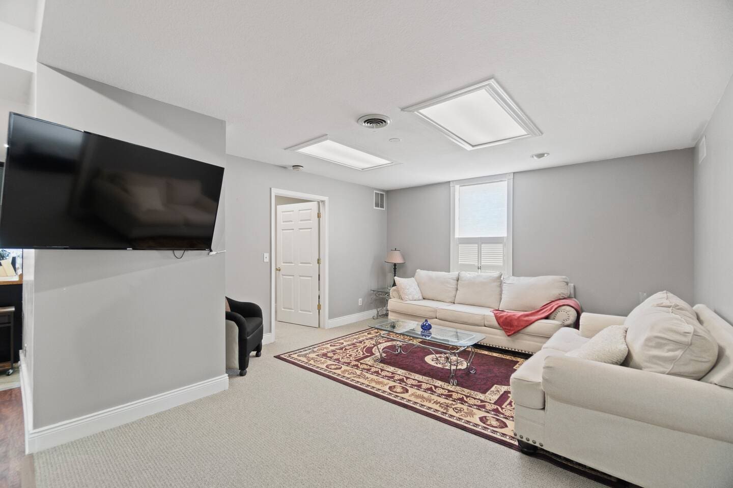 Upstairs living room featuring a cozy atmosphere with a flat-screen TV, perfect for entertainment and relaxation.