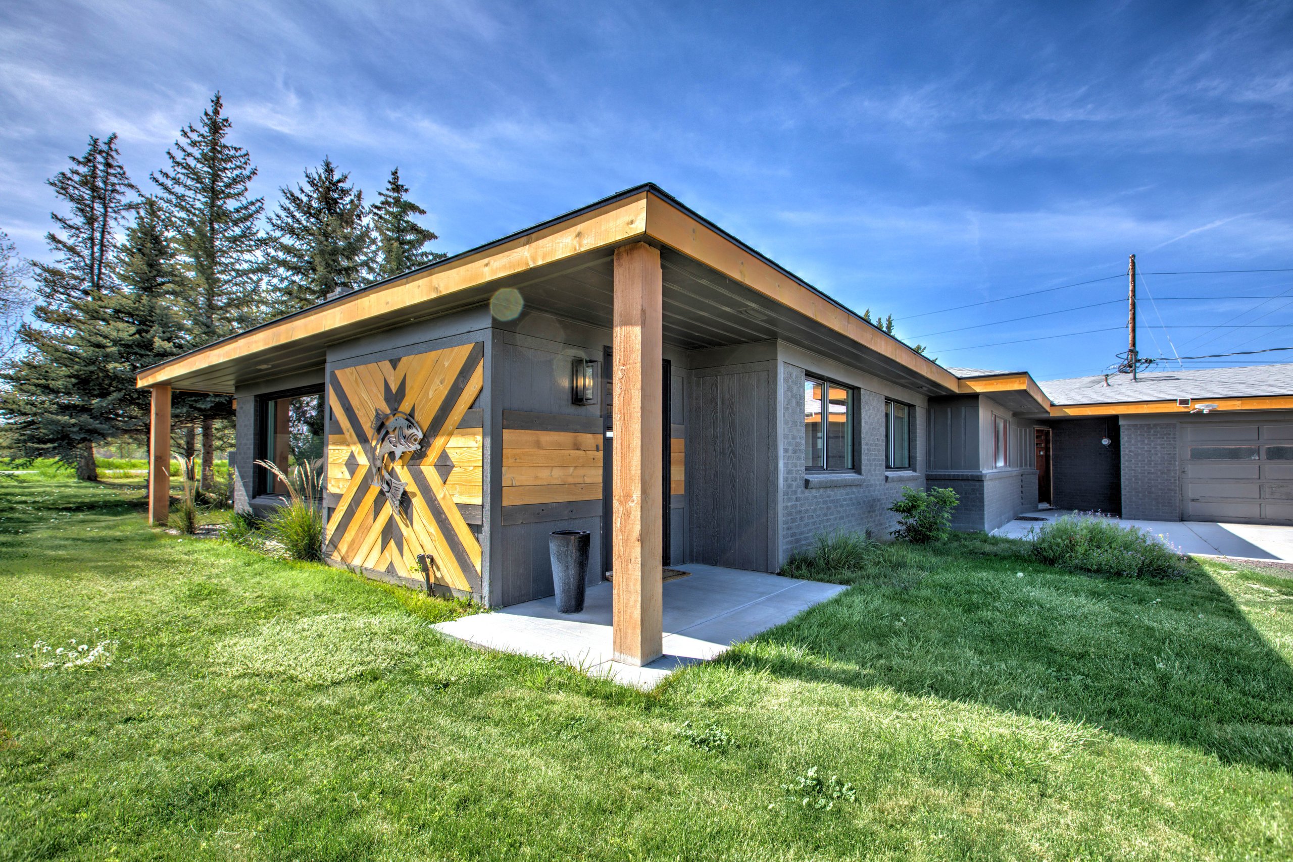 Welcome to Unit 2 — the mid-century home framed by its signature metal fish art