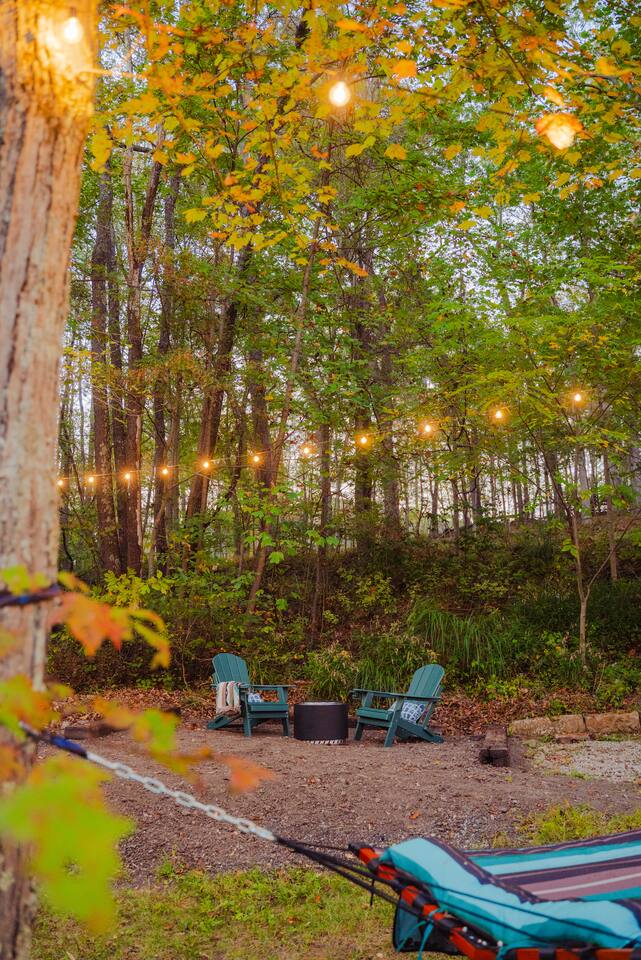 String lights hang softly in the trees, creating a magical & peaceful atmosphere. 