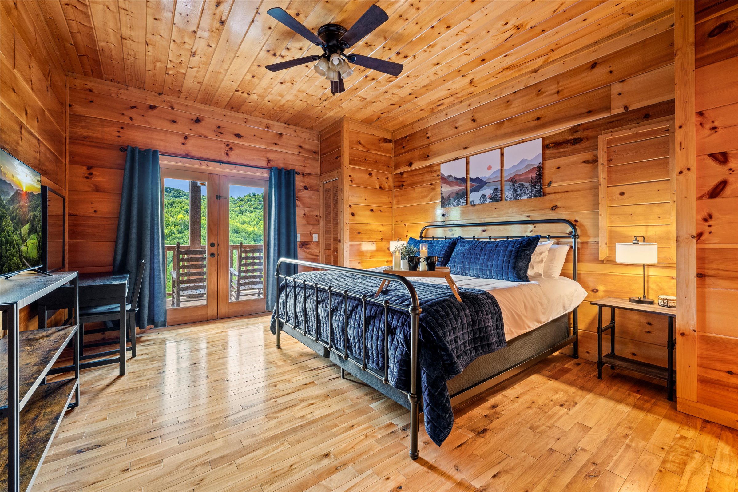 Spacious and inviting, this second king ensuite downstairs offers comfort, TV, and deck access.