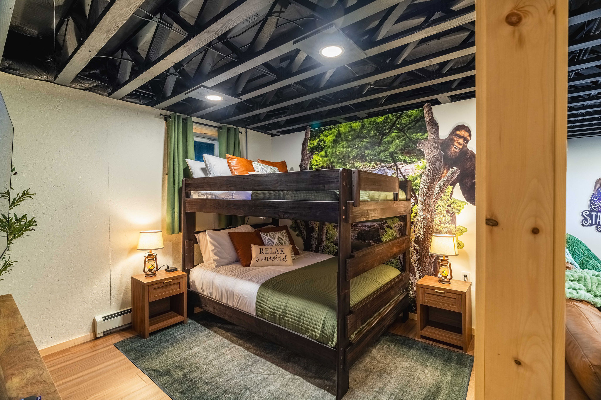 👣 Bigfoot Room 1: queen-over-queen bunk (sleeps 4), 55" HDTV and a Bigfoot mural
