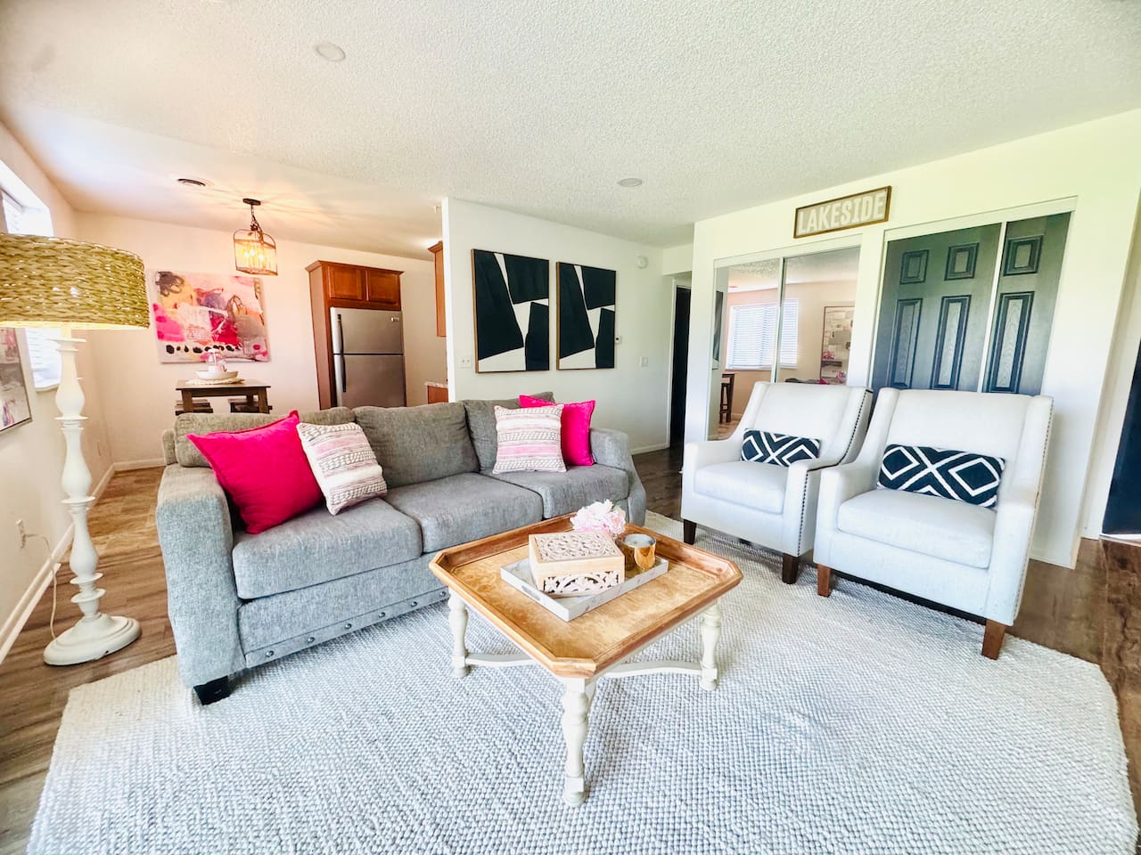 Bright and inviting living space with colorful floral decor, comfortable seating, and a playful area rug. Sliding glass doors open to scenic views, filling the room with natural light—perfect for morning coffee or evening unwinding.