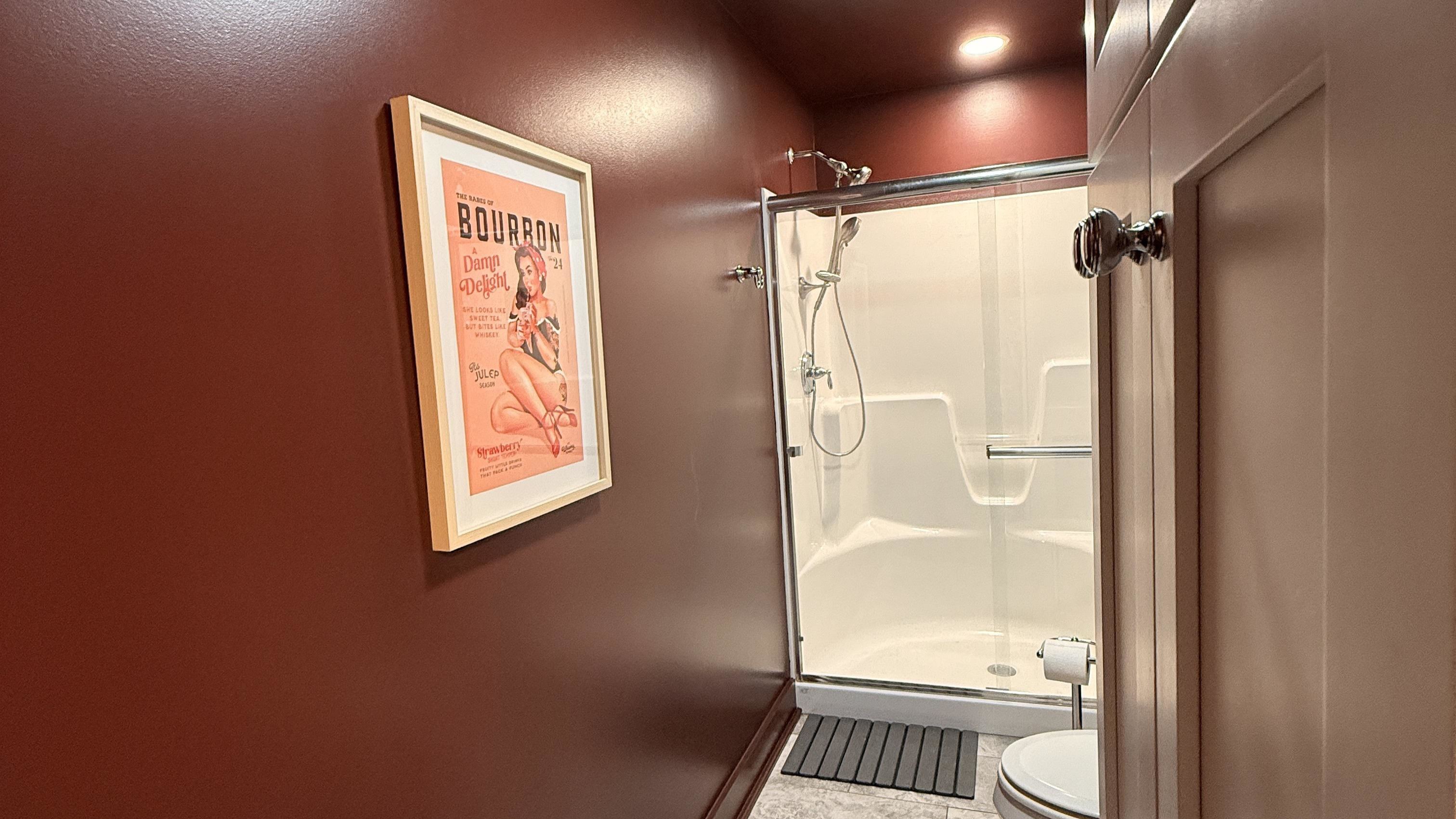Playful charm meets polished design — a nod to bourbon’s bold spirit and timeless allure. This shared bathroom balances function and flair, offering guests a stylish space to refresh between evenings of laughter and late-night stories.