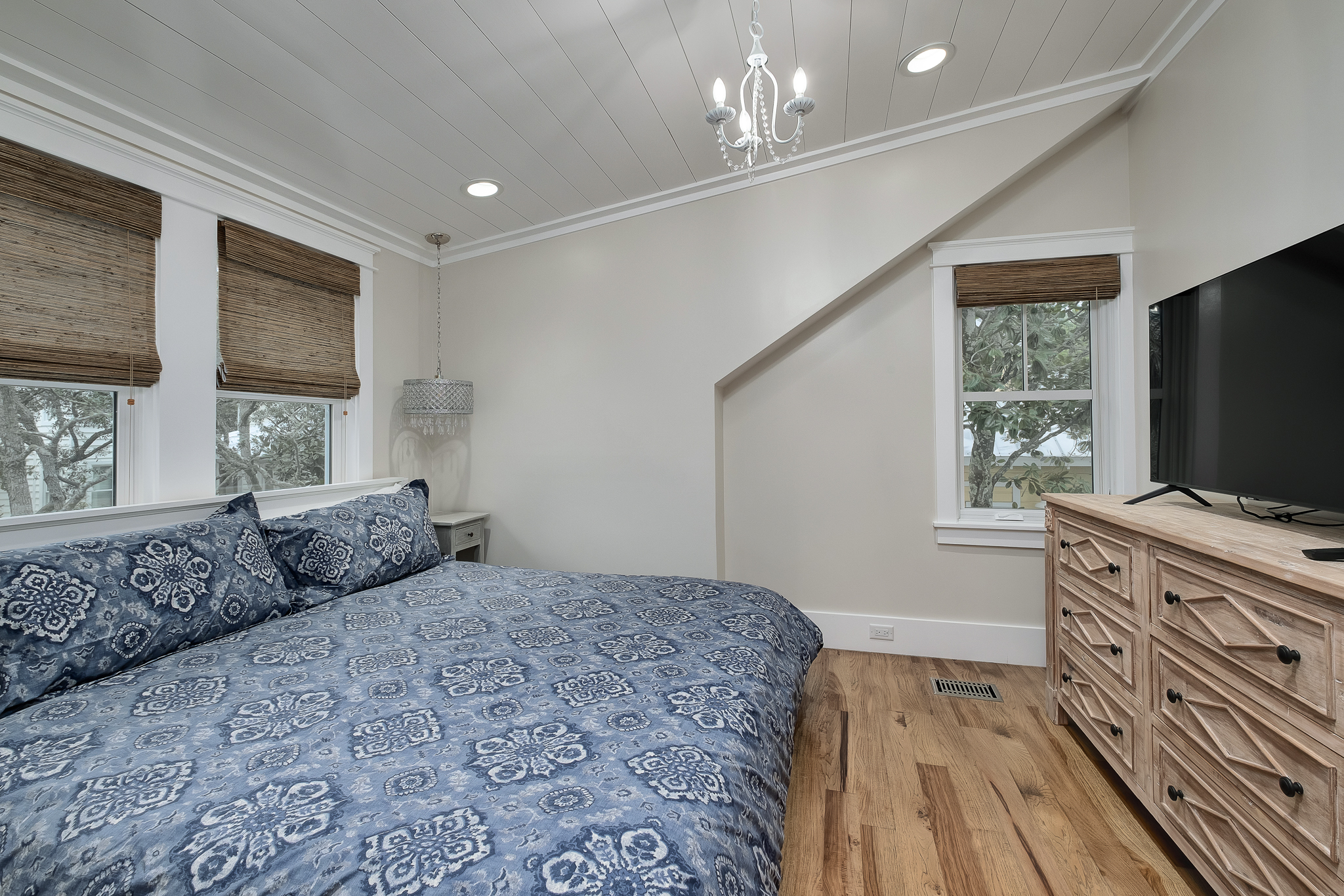 King bedroom with large dresser and ensuite bath.