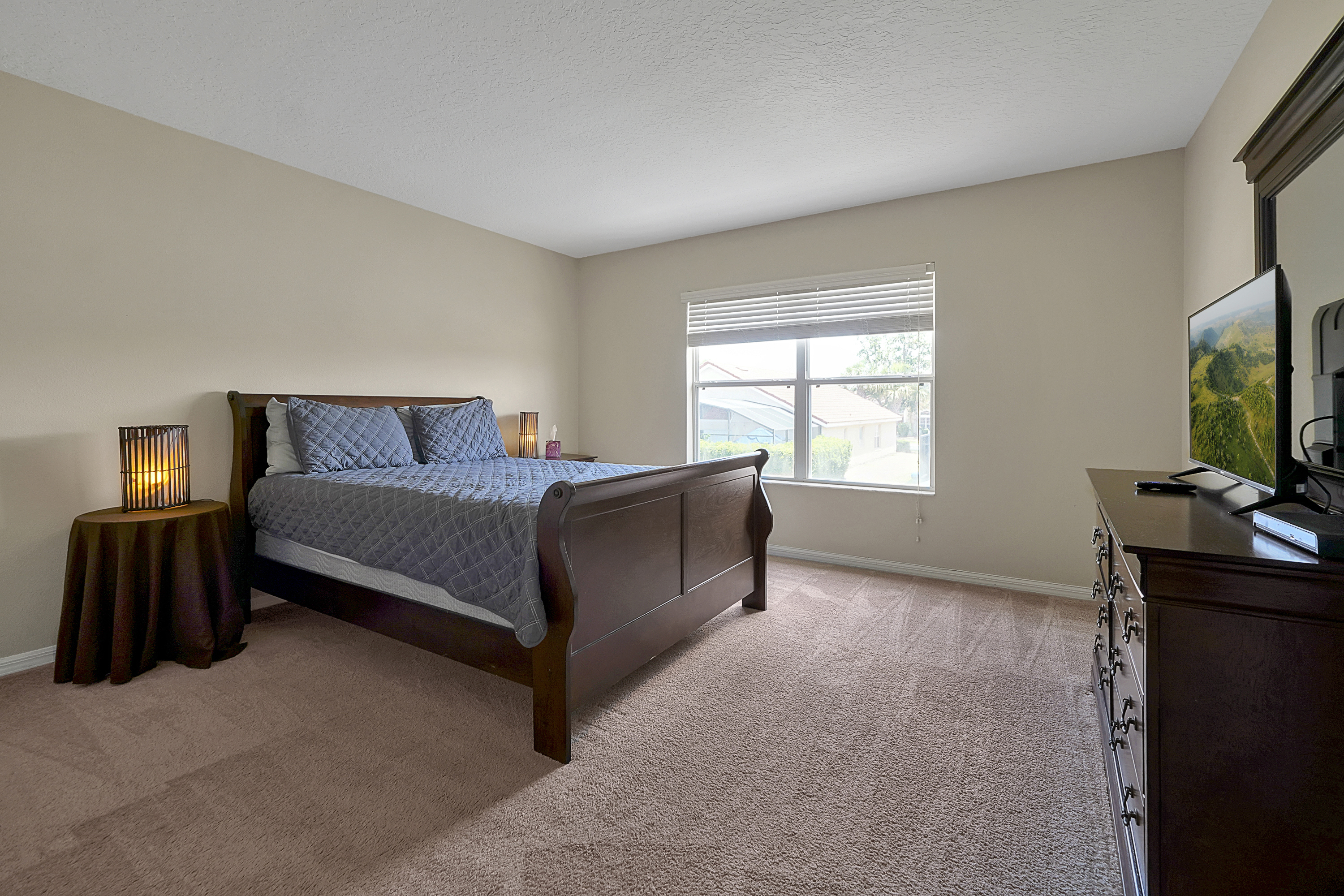 Retreat to a private escape upstairs: a comfortable queen bedroom perfect for quiet downtime, complete with a dedicated flat-screen TV 