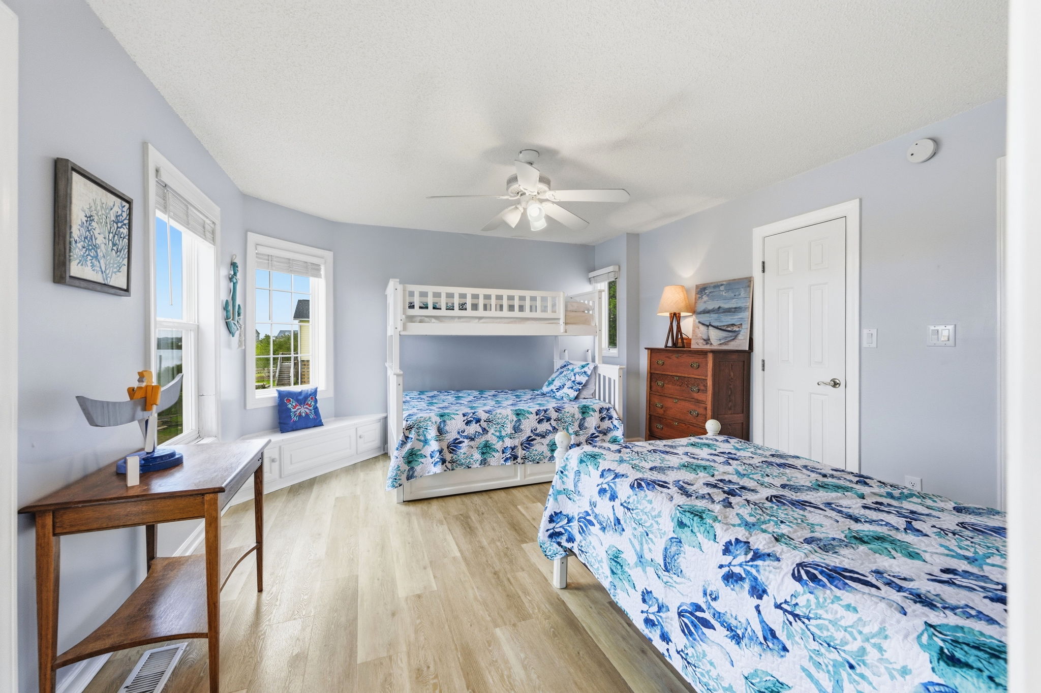 This spacious bunk room features a twin over full bunk bed and an additional twin sized bed. Built for sleepovers, giggles, and late-night stories!