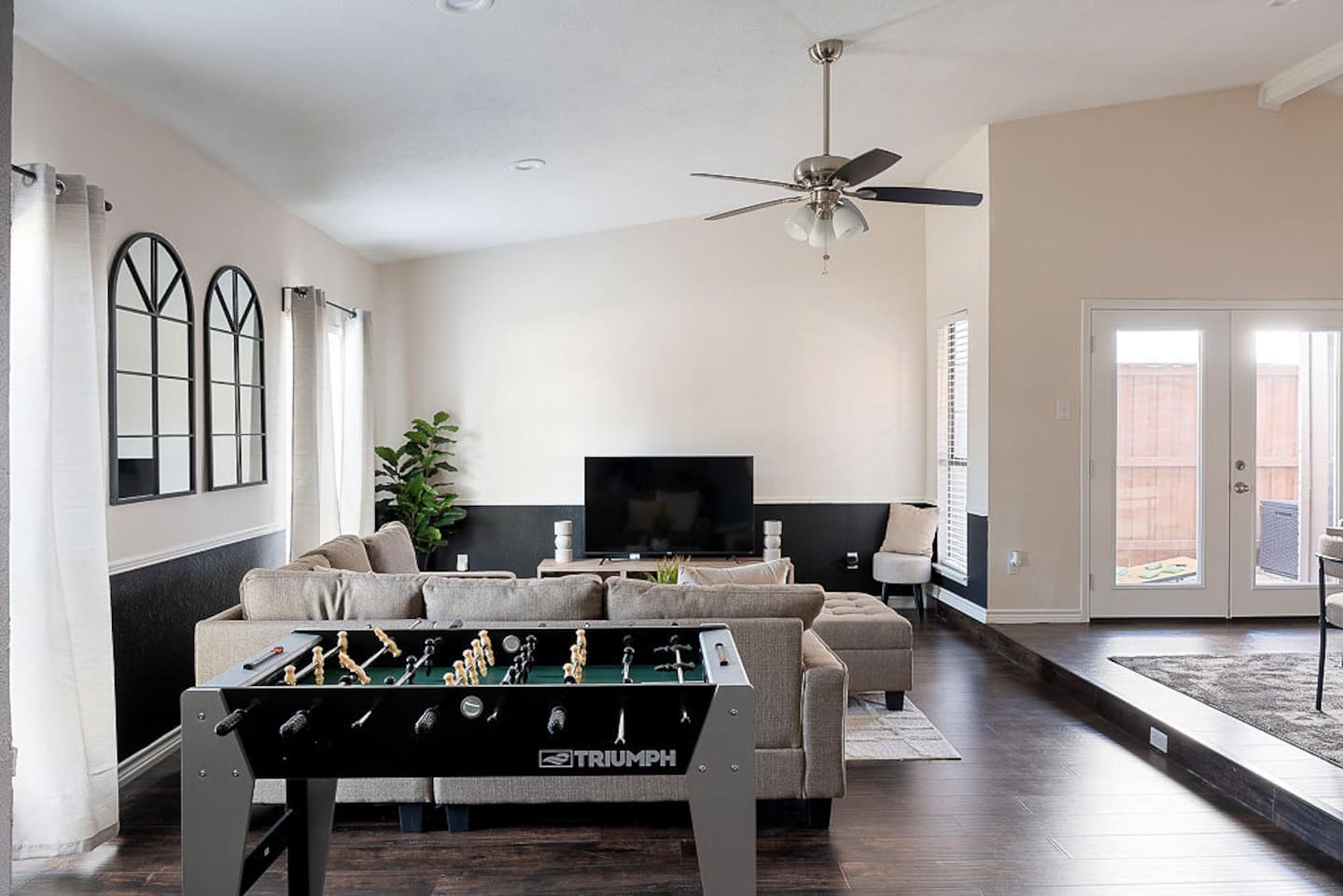 Relax on the comfortable couch next to the 65" HDTV or stand for a game of foosball