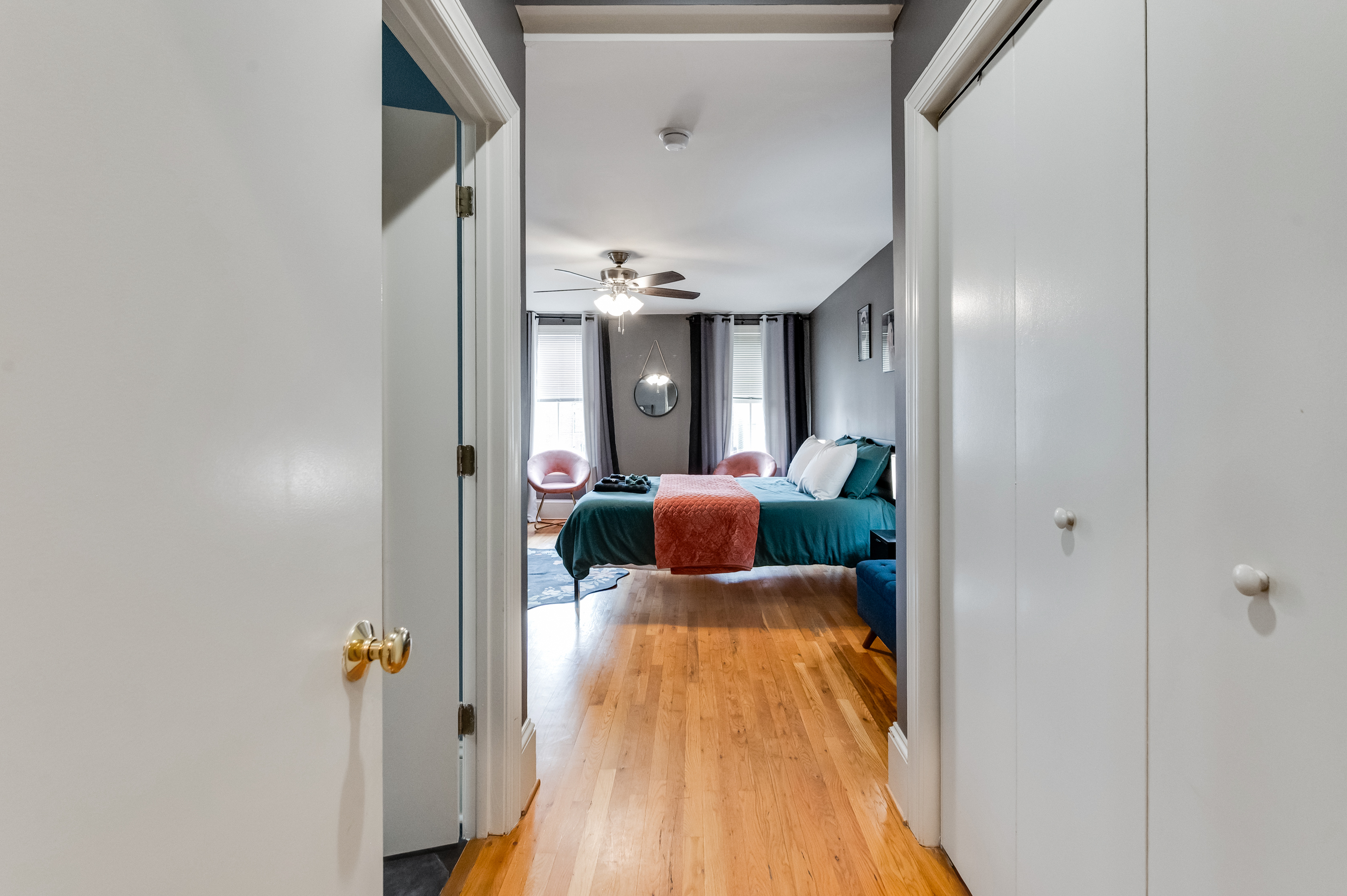 Queen Bedroom 3: Relax in a stylish retreat with vibrant decor and warm wood floors!