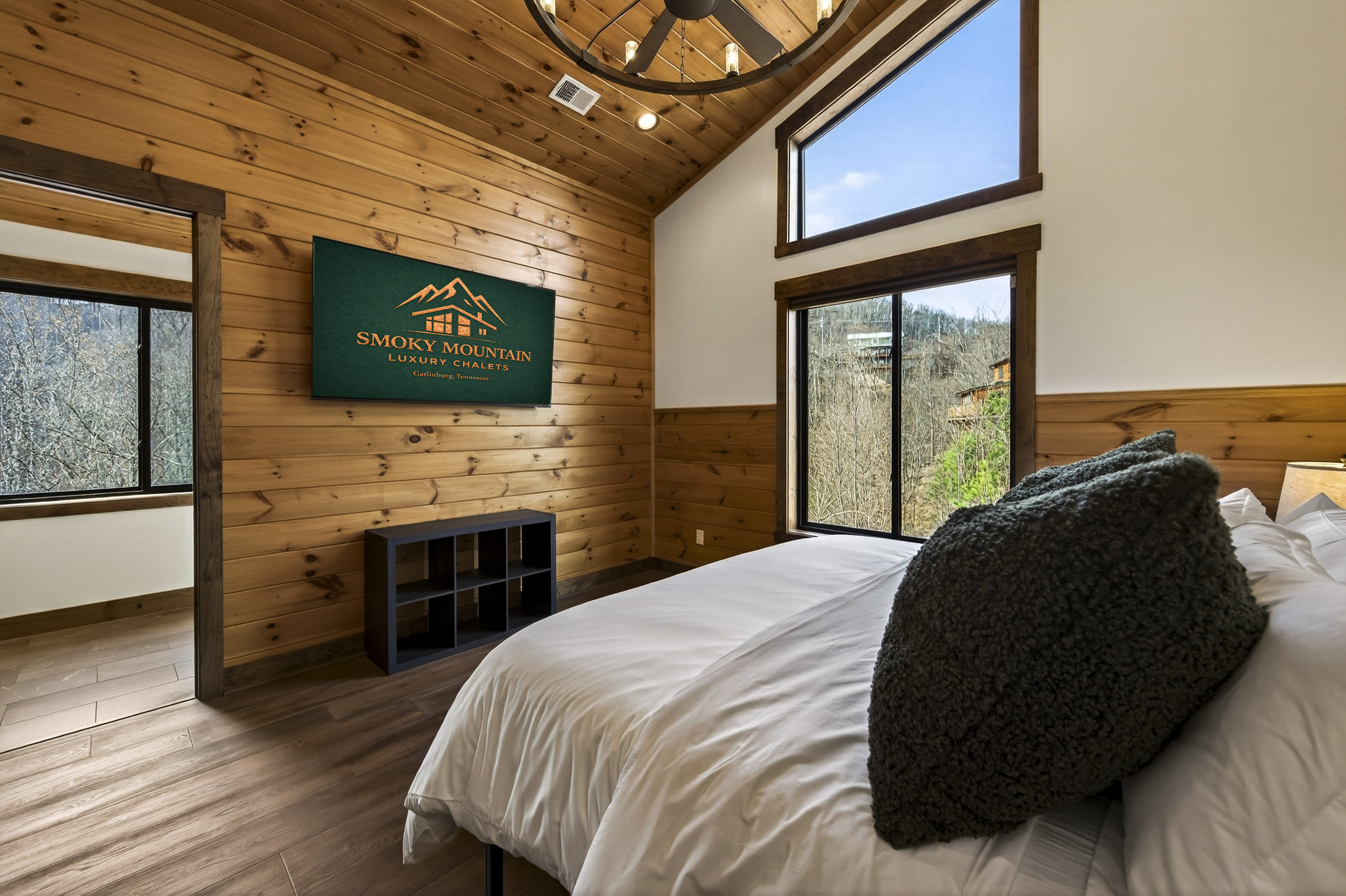 King Suite with vaulted ceilings an x-large TV. Unwind in the en-suite bathroom featuring a luxurious walk-in shower with a natural river rock floor, bringing  the Smoky Mountains indoors for a spa retreat.