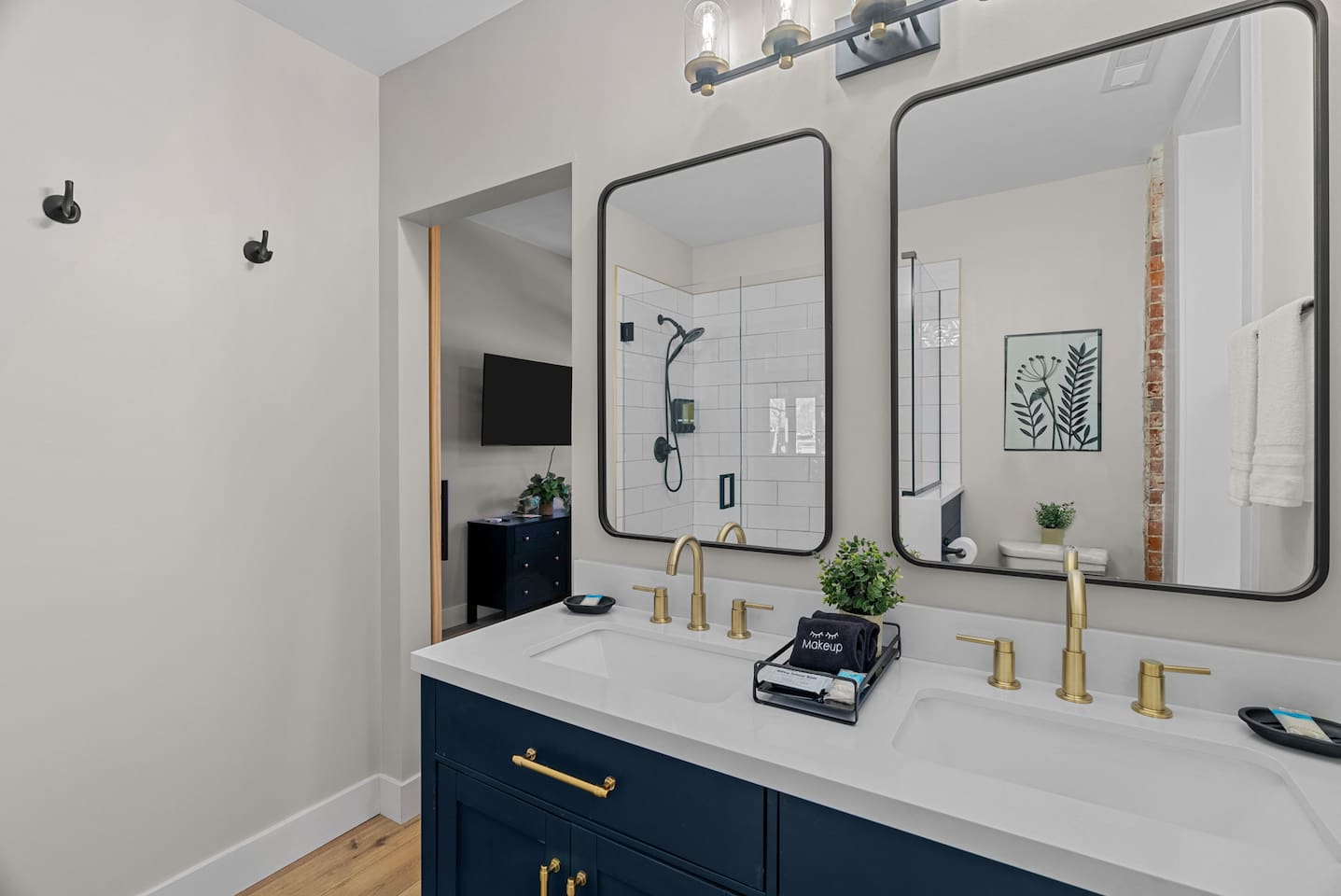 Master bath with dual vanity stocked with some essentials including hair dryer.