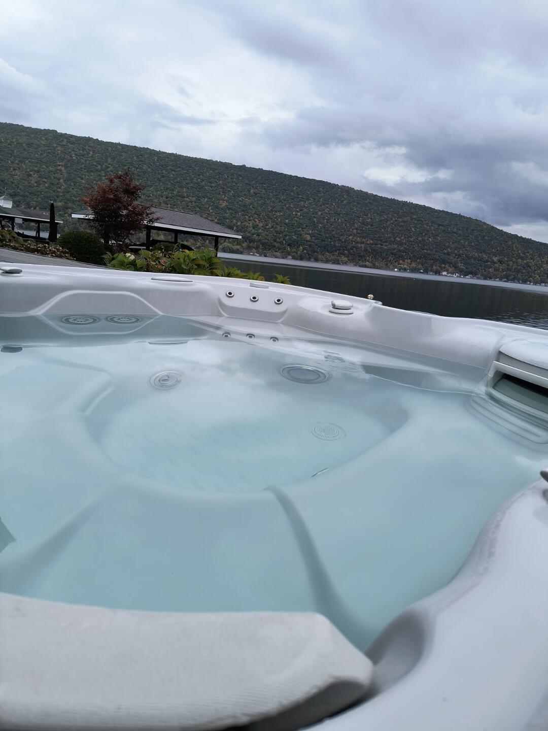 Soak in the hot tub while enjoying the views of the lake