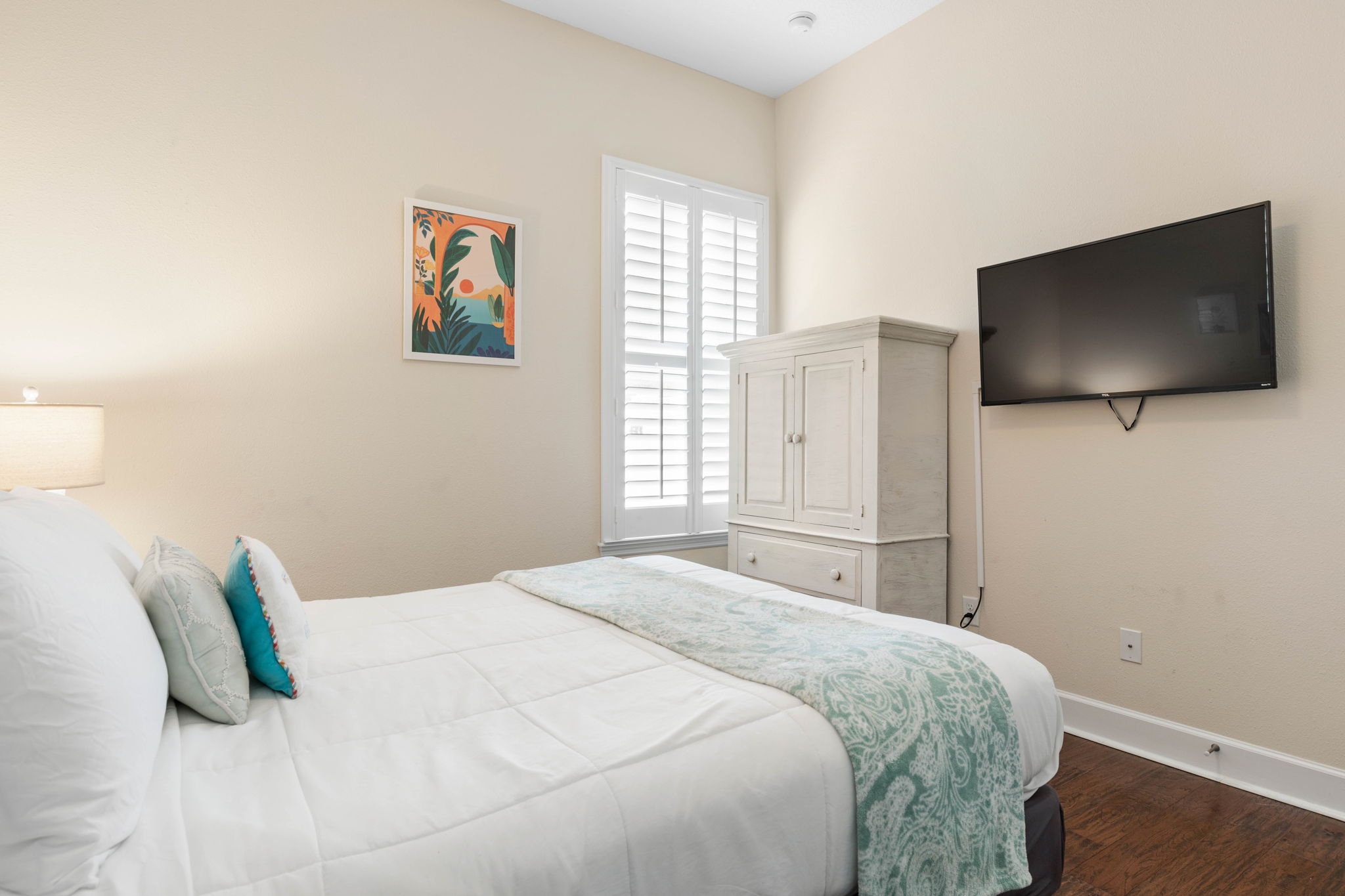 Close the door, sink into crisp sheets, and unwind with your favorite show after a sun-filled beach day—this cozy coastal bedroom is made for quiet mornings, early nights, and the kind of rest that makes vacation feel complete.