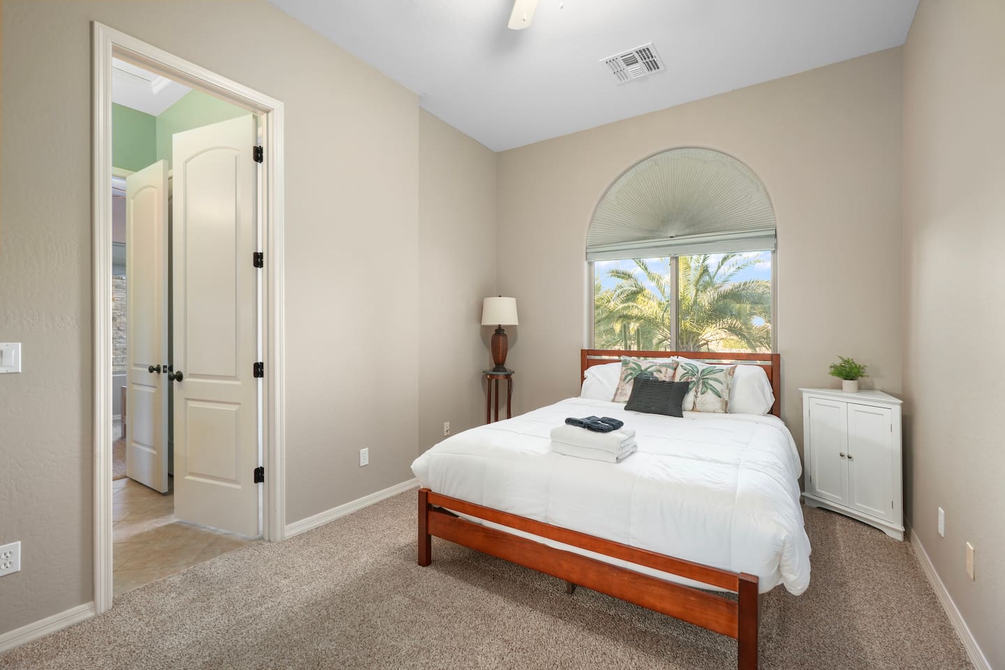 Comfortable queen bedroom with natural light and peaceful desert views.
