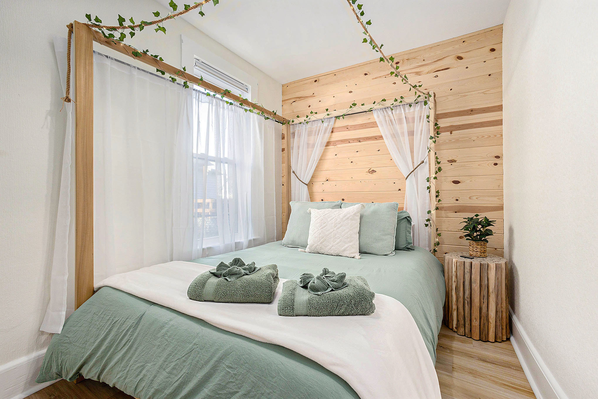 Romantic Queen canopy bed with light-up vines and sheer curtains