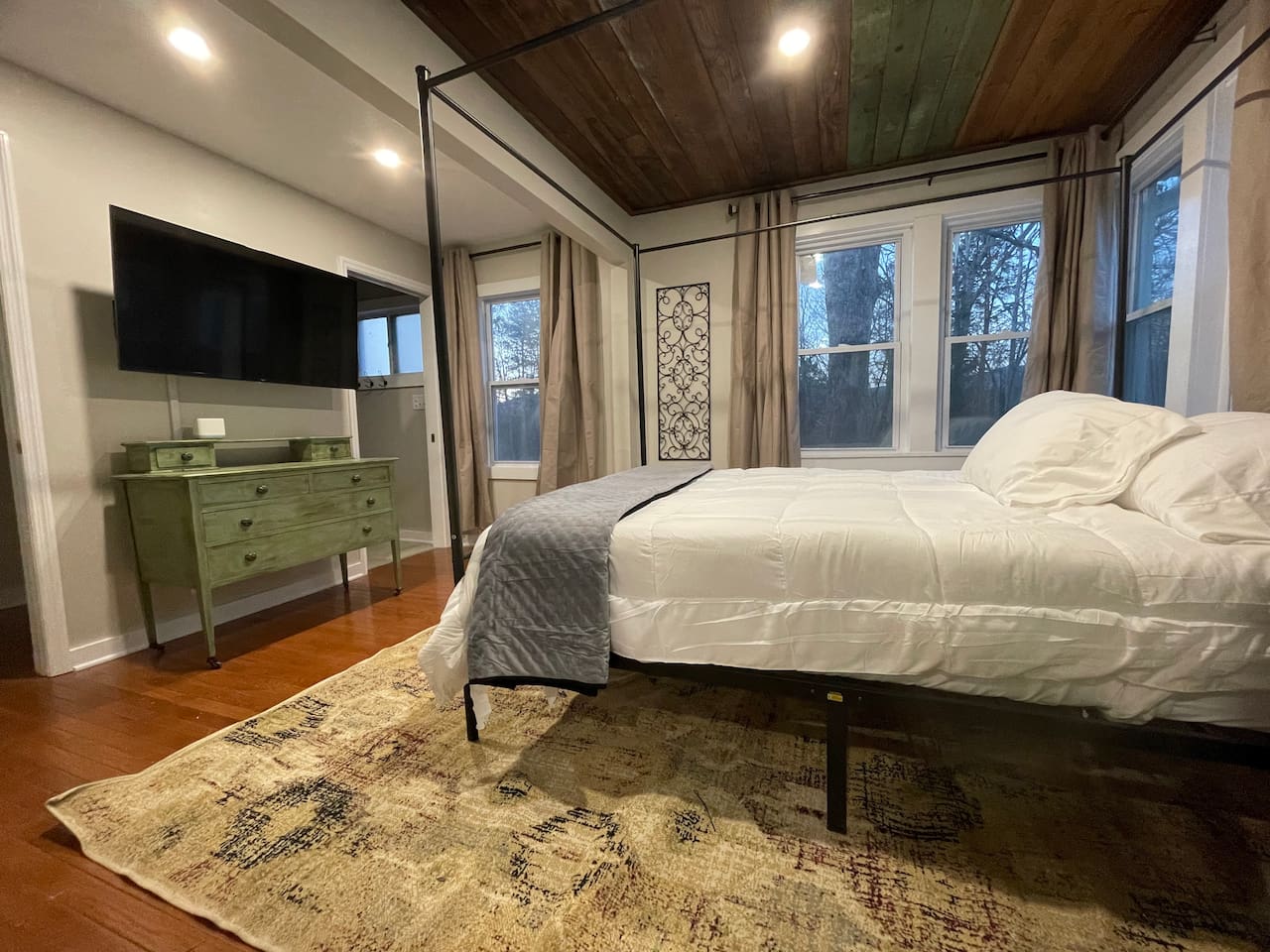 Master bedroom with private bathroom. Open windows to check out the quiet outdoors