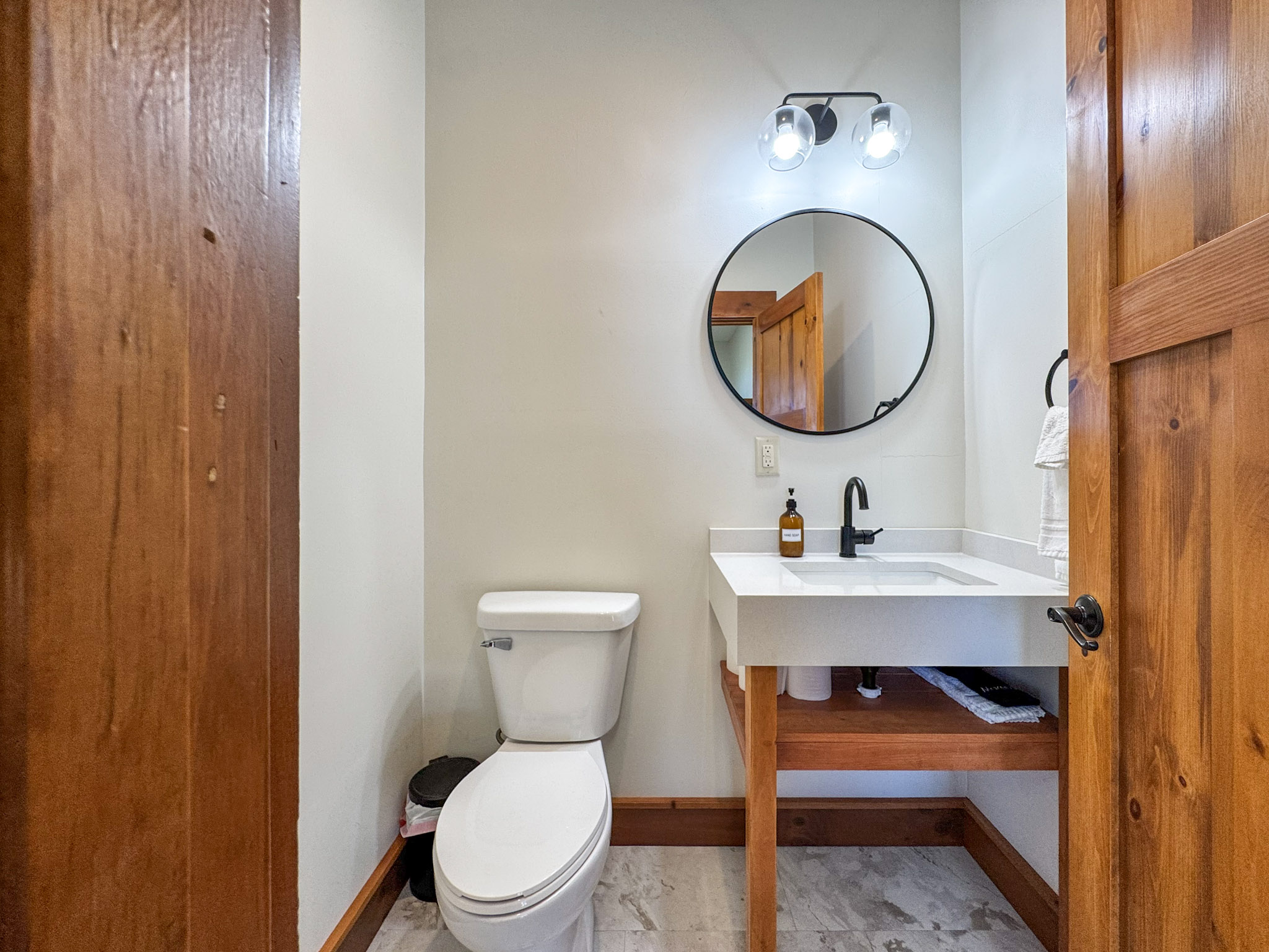 Half bath by the laundry area and indoor pickleball court.