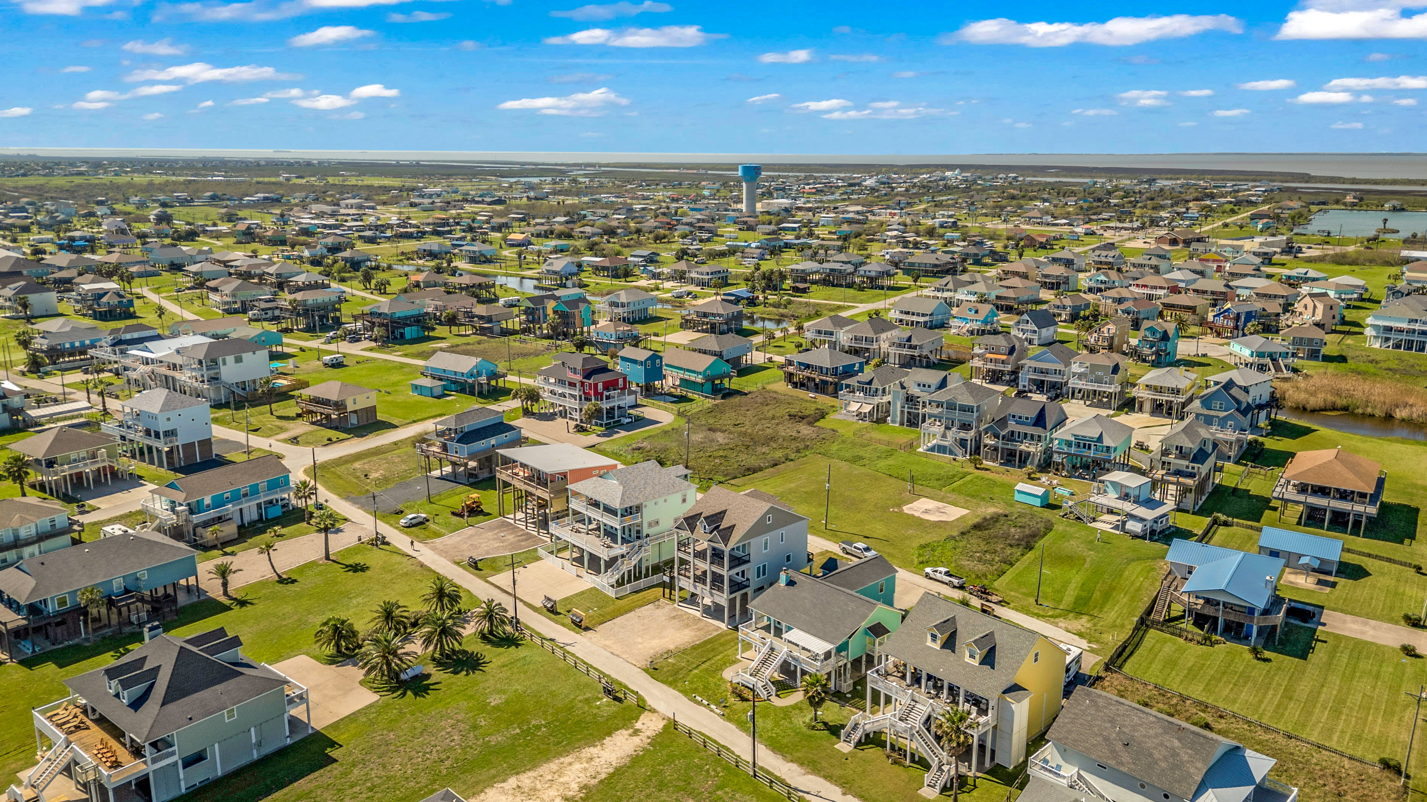 Costa Cristal Exterior: From the sky, the estate unfolds like a masterpiece, grand homes, pristine grounds, and winding paths perfectly blending luxury and nature. The aerial perspective captures the scale and elegance of the entire property.