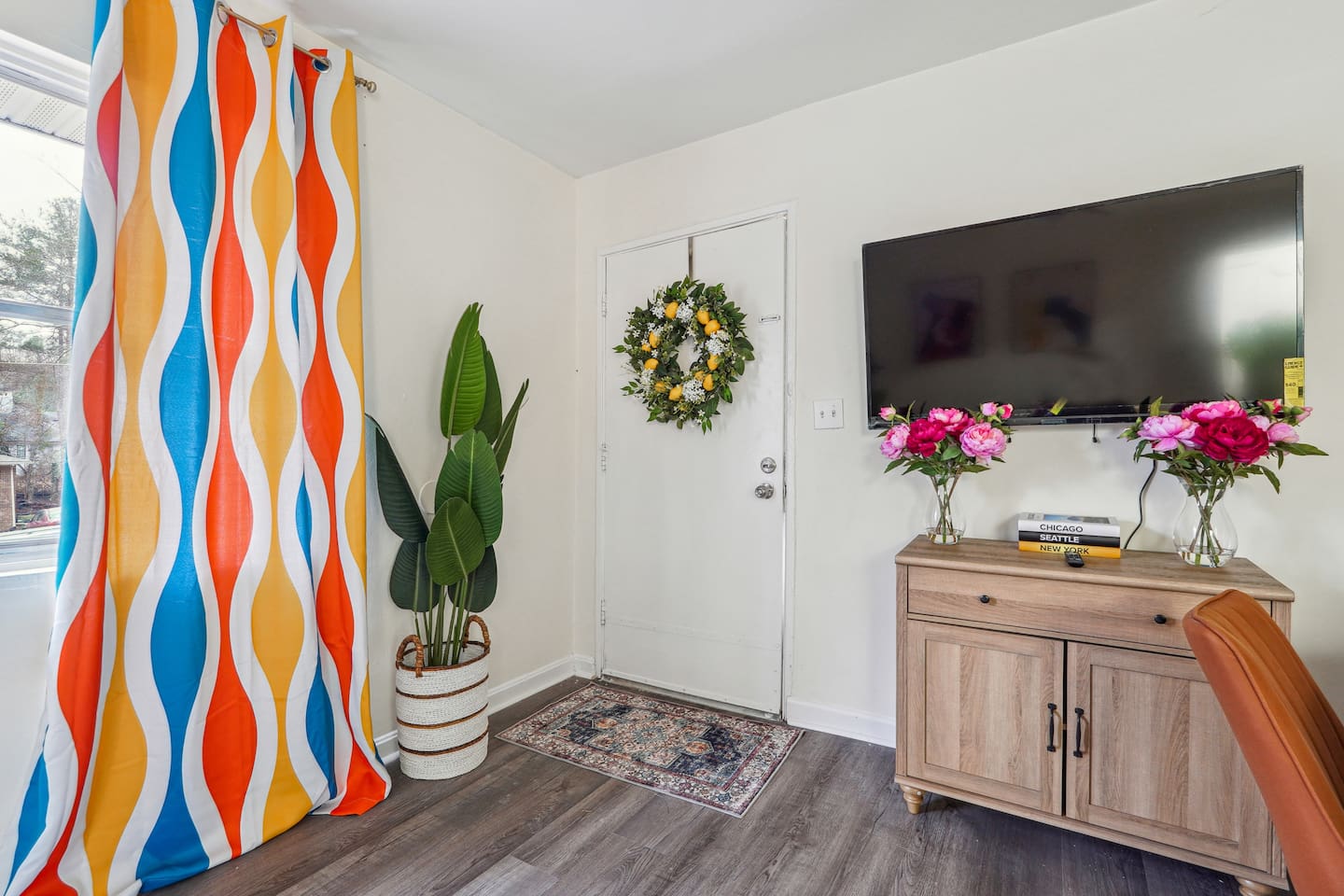 Enjoy a cozy living room featuring a comfortable couches, a TV for your entertainment, and a window with a lovely view outside, perfect for relaxing and unwinding.