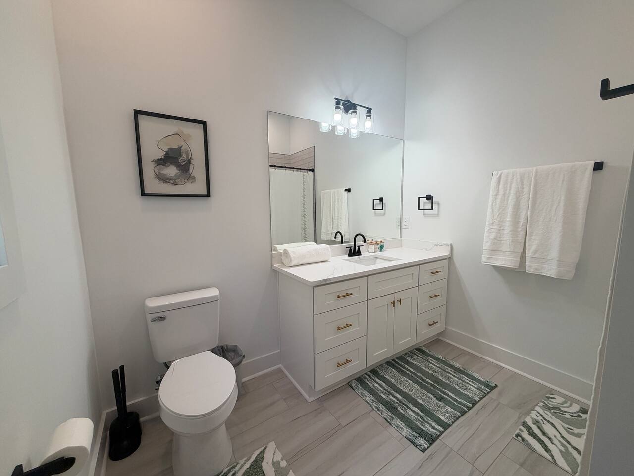 Bathroom connected with downstairs bedroom with king bed.