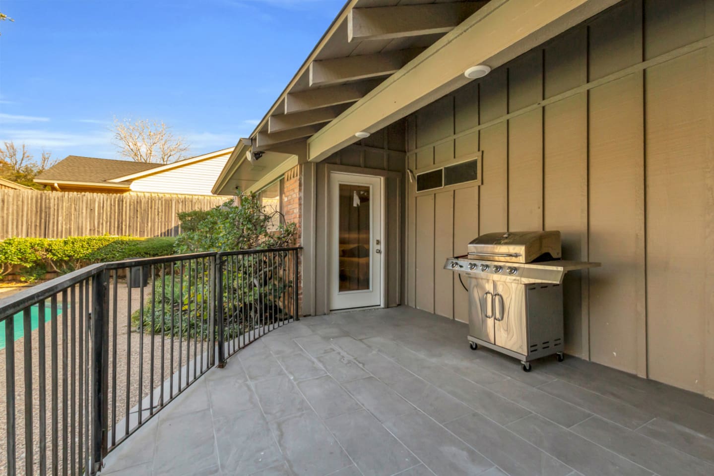 Gas BBQ grill with provided grilling utensils, making it easy to prepare outdoor meals and enjoy relaxed backyard dining.