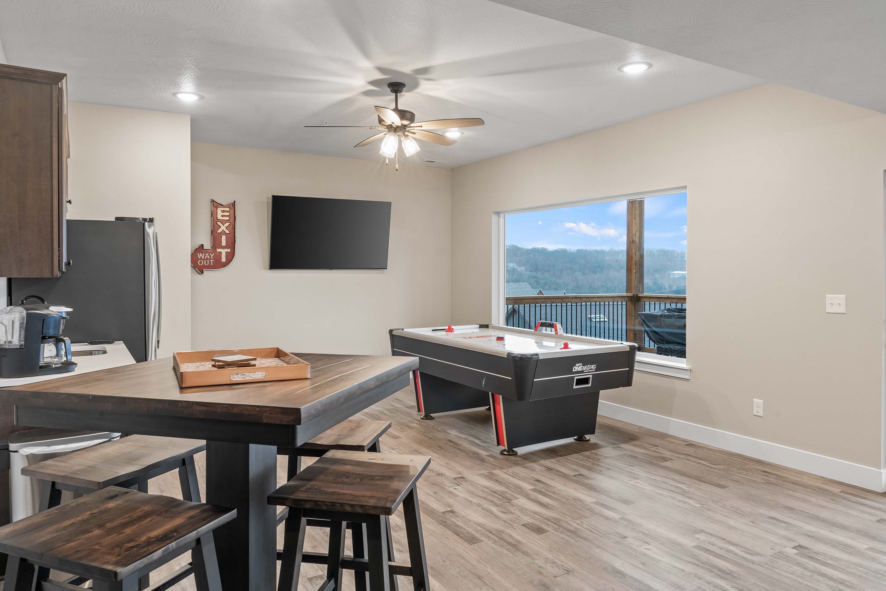 Rec Room has an air hockey table, pub table that seats four, TV and a kitchenette with coffee maker, large refrigerator/freezer with ice maker. Perfect area for the family to spend time together.