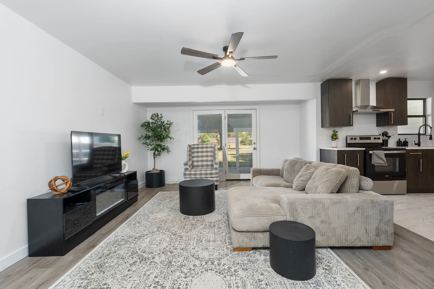Bright and inviting living room featuring a plush sofa, Smart TV with Netflix and Roku, and access to the covered porch. Perfect for cozy nights in or streaming your favorite shows after exploring Grand Prairie.
