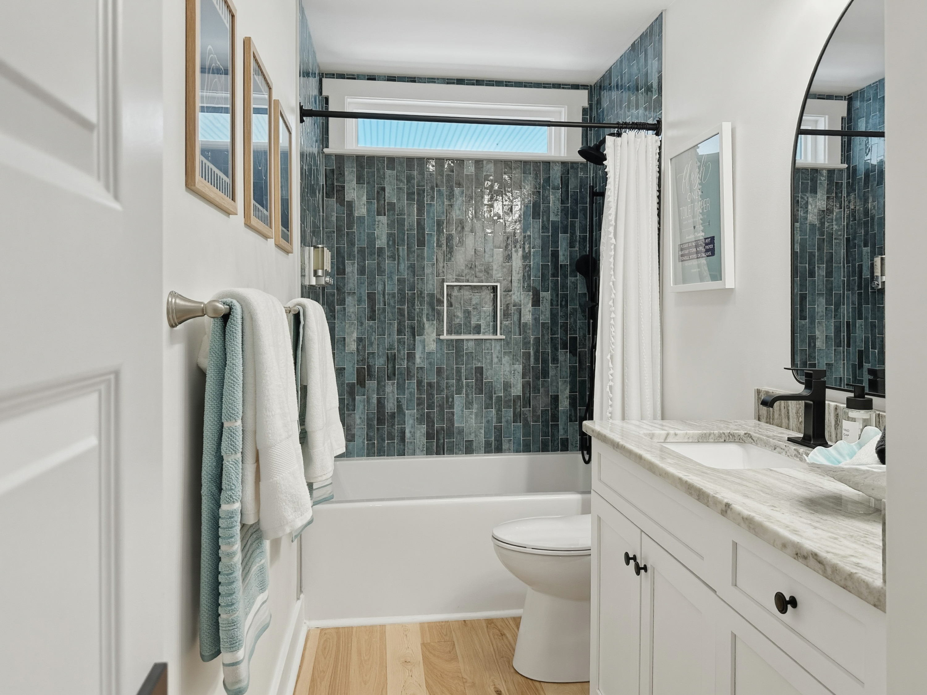 And a beautifully tiled shower/tub combo.