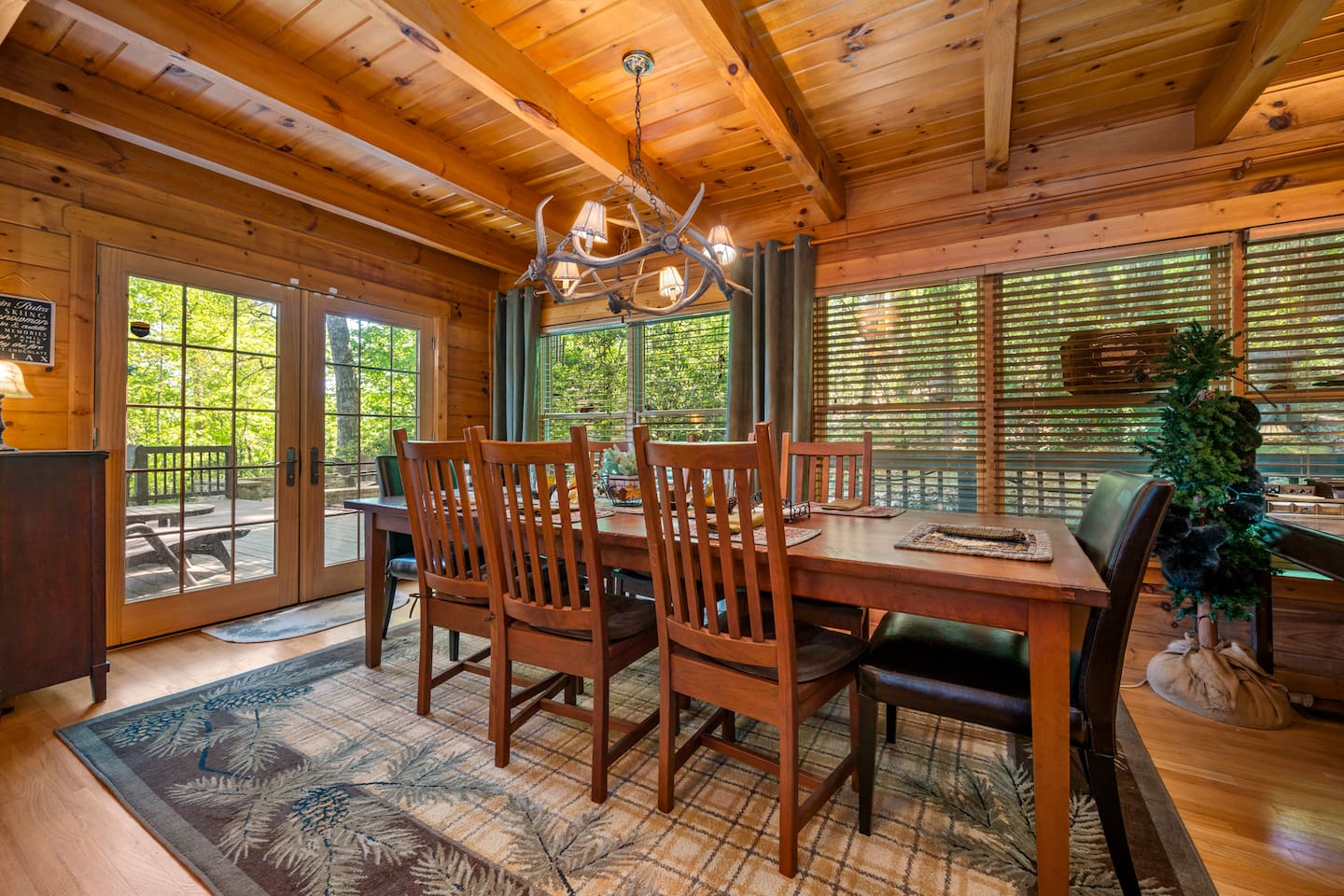 Enjoy meals surrounded by natural light and peaceful wooded views, with easy access to the outdoor deck for indoor-outdoor mountain living.