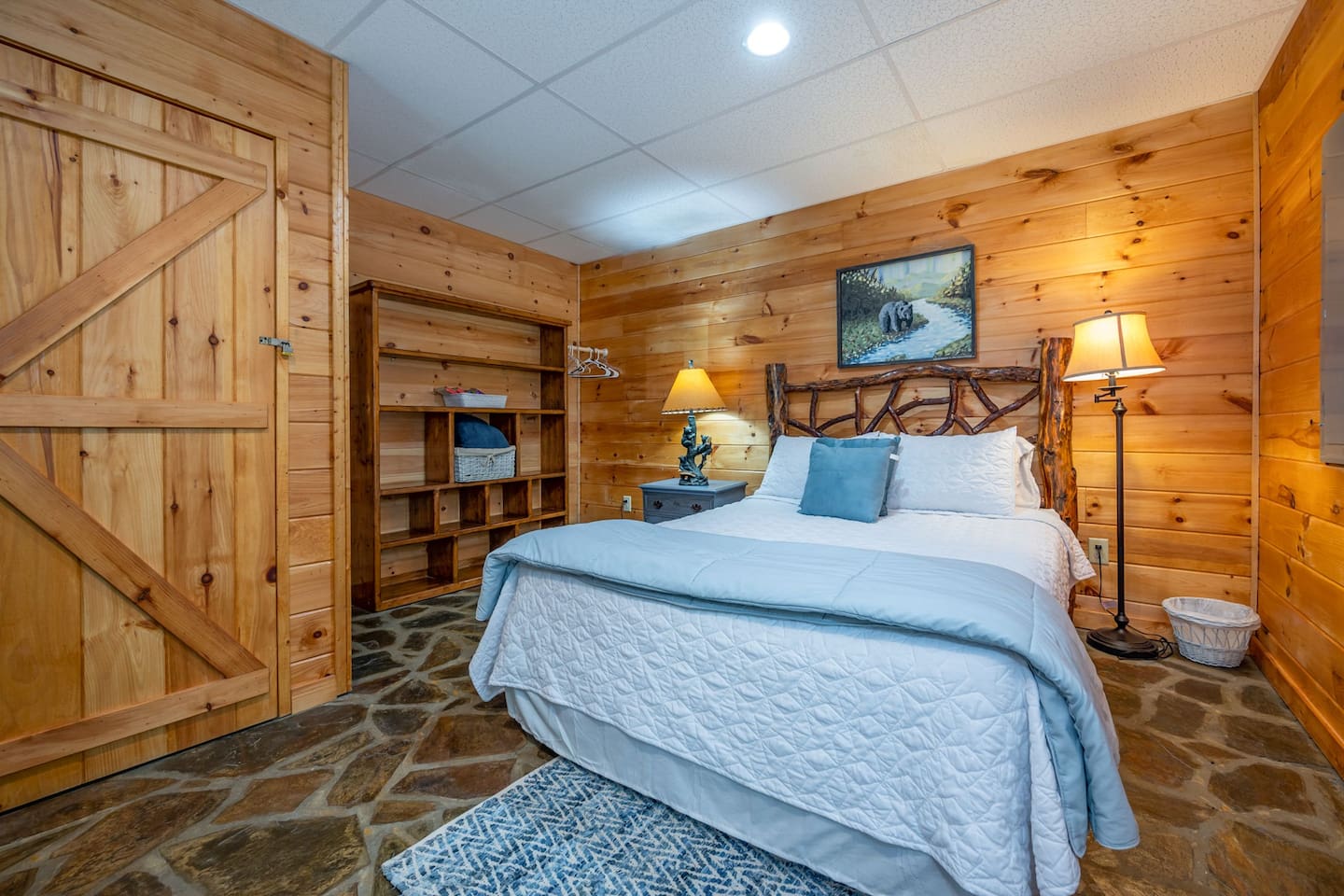 Downstairs 3rd master with French Doors to hot tub and beautiful native stone floors. Large bedroom