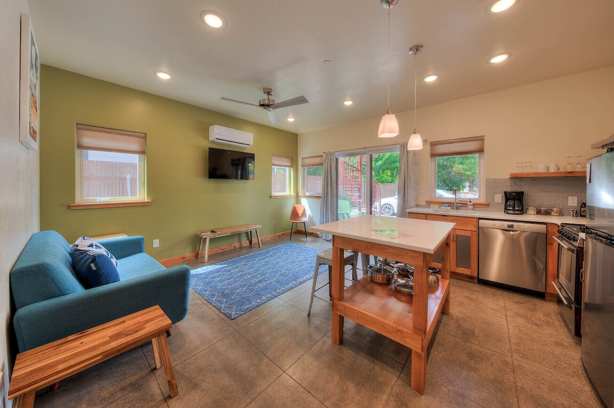 Open concept family room and kitchen with high ceilings