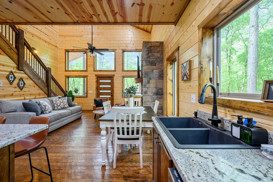 Scenic kitchen and dining area with beautiful forest views through oversized windows