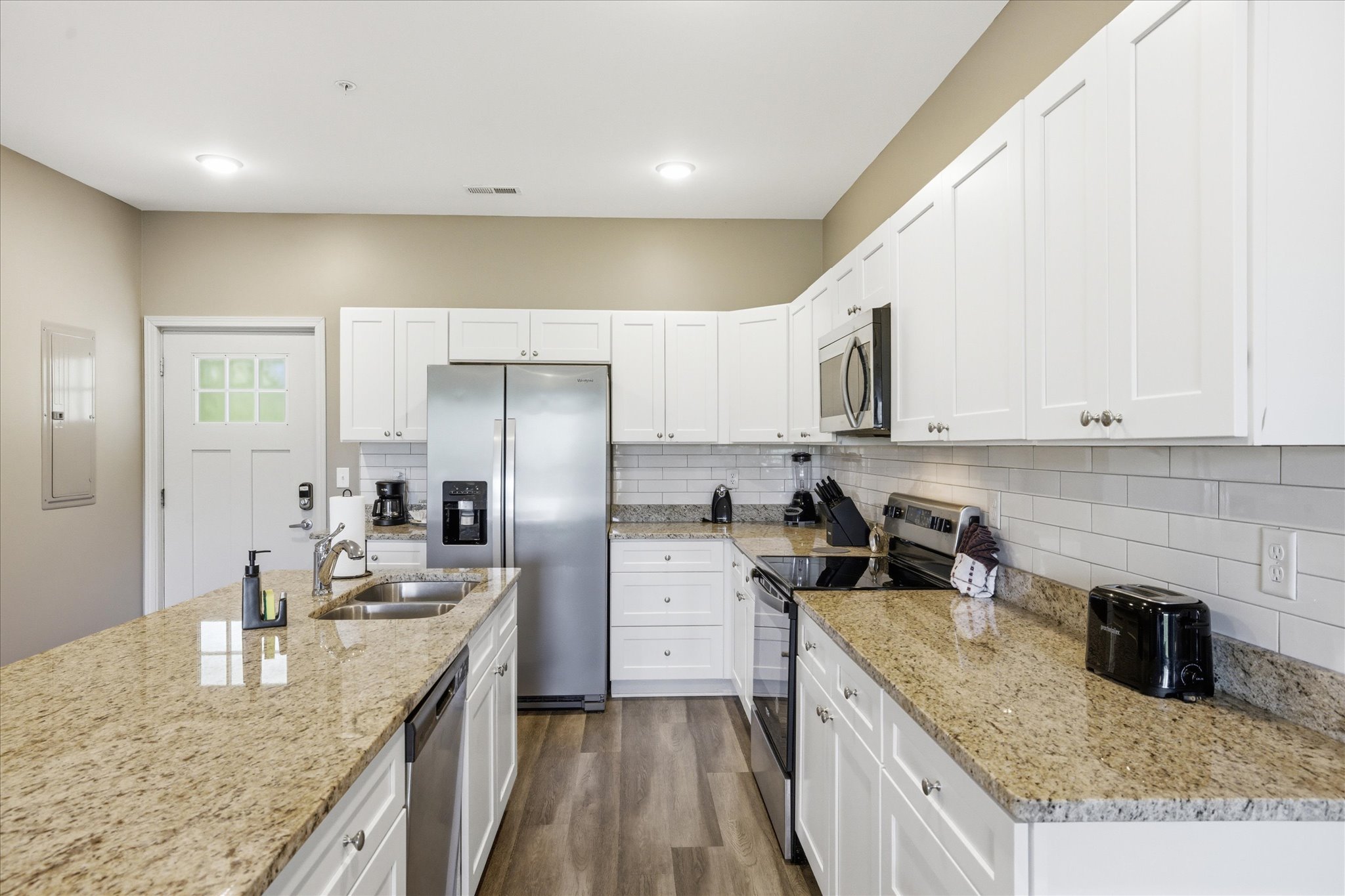 This kitchen in Unit 4 is ready to go—clean finishes, plenty of counter space, and a setup that makes cooking feel easy even with people moving around.