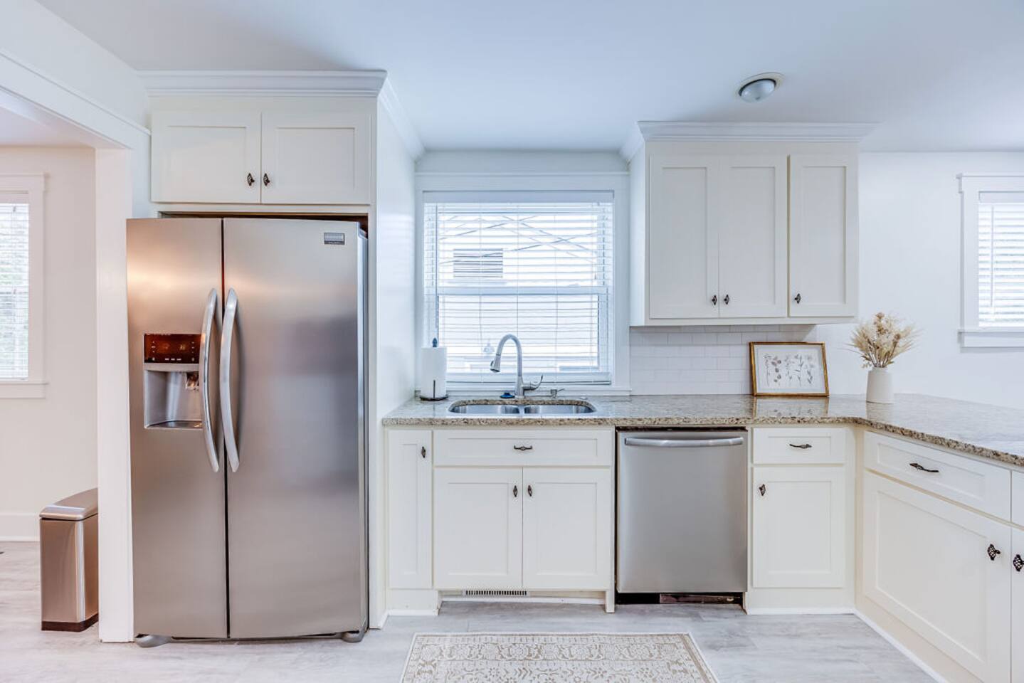 Fully equipped kitchen with sleek, white interiors, offering a bright and airy space to cook and gather.
