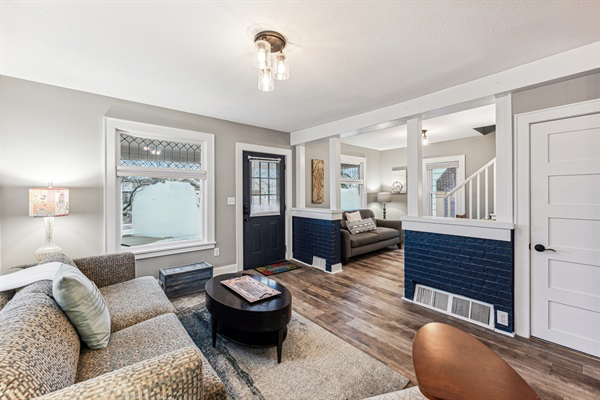 Living room into our cozy foyer with additional seating and desk area.
