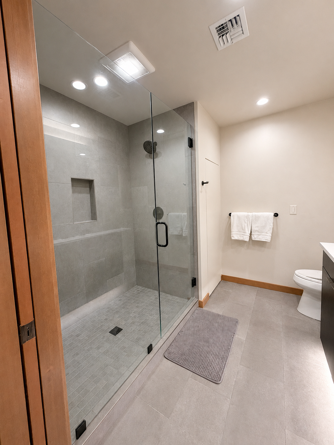 Spacious glass-enclosed walk-in shower.