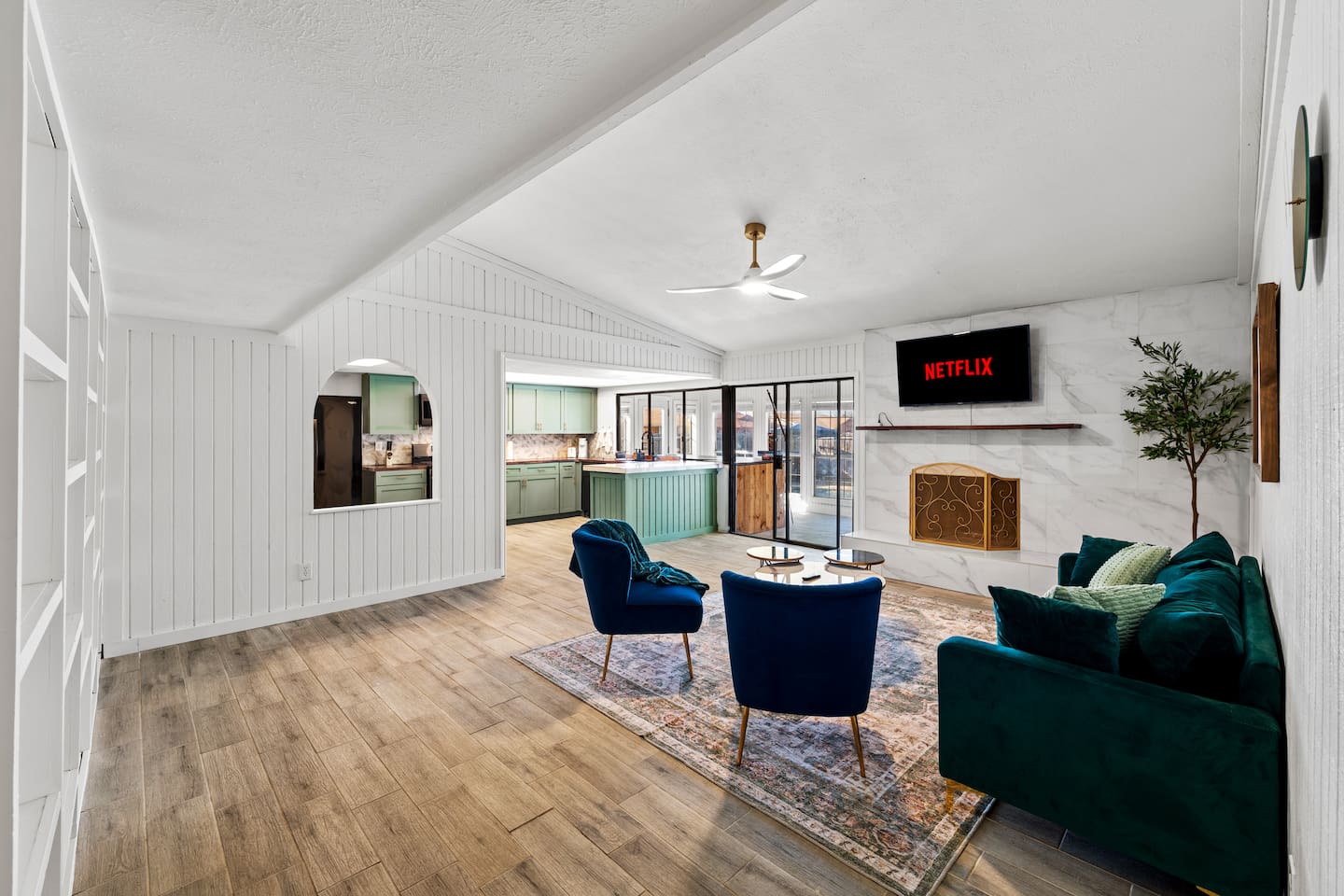 Relax in this stylish living room with plush seating, smart TV, and natural light—perfect for groups and families.