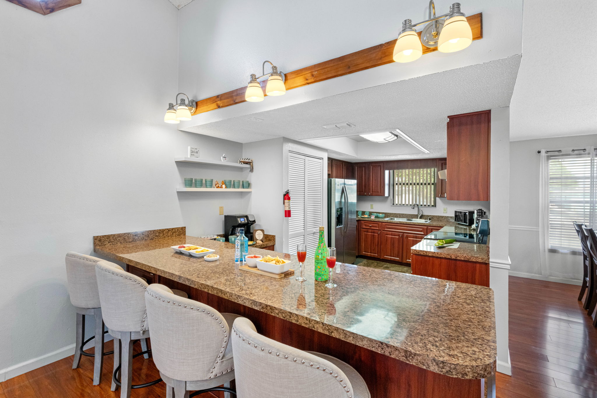 The extended countertops double as a bar, making this kitchen a great hub for casual dining, wine and cheese nights, or morning coffee chats.
