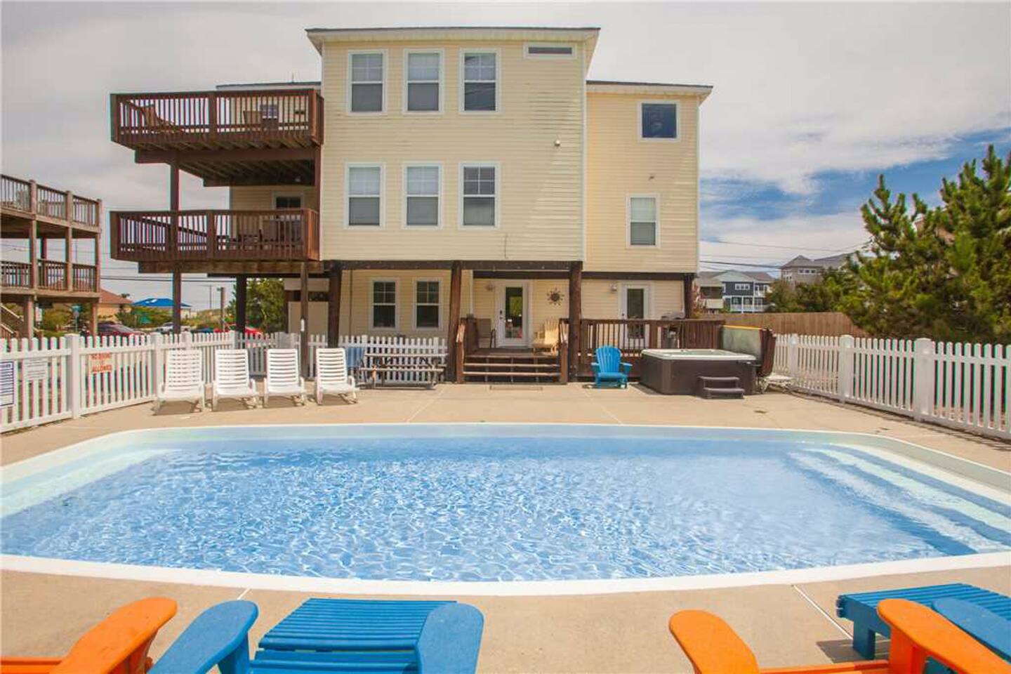 back of the house with pool and hot tub