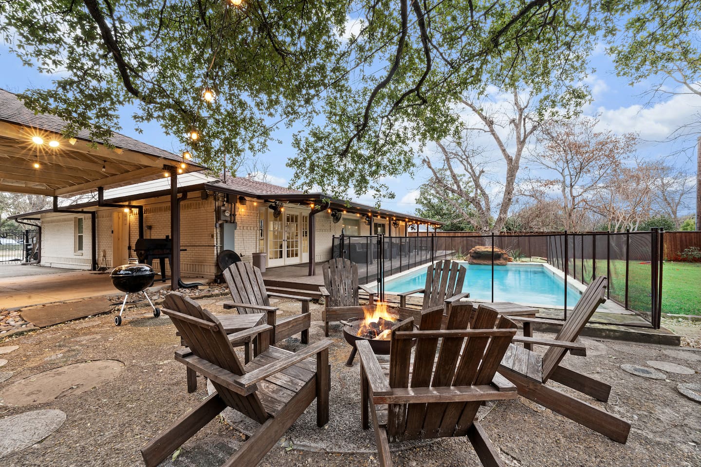 Evenings are better around the fire pit with comfy Adirondack chairs and string lighting under mature trees.