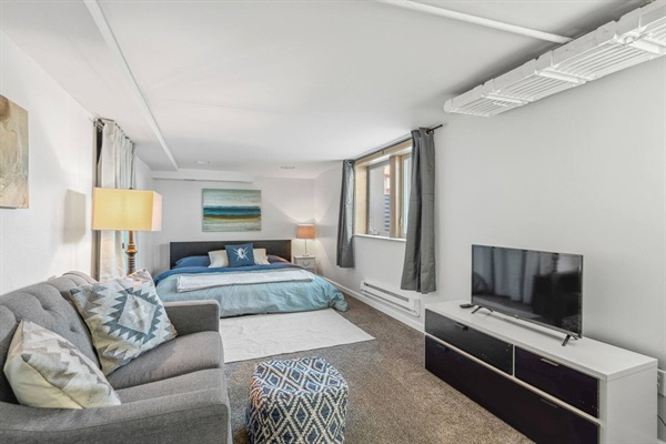 King bed in the "Cave Den Room" Also has a cozy love seat and television