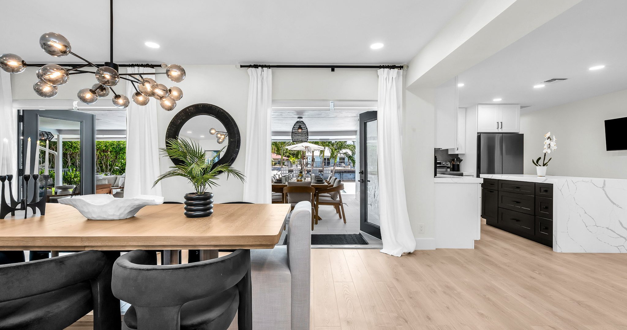 Experience resort-style dining with a designer table for 8 indoors and al fresco seating for 10 by the pool, offering an elegant backdrop for unforgettable gatherings