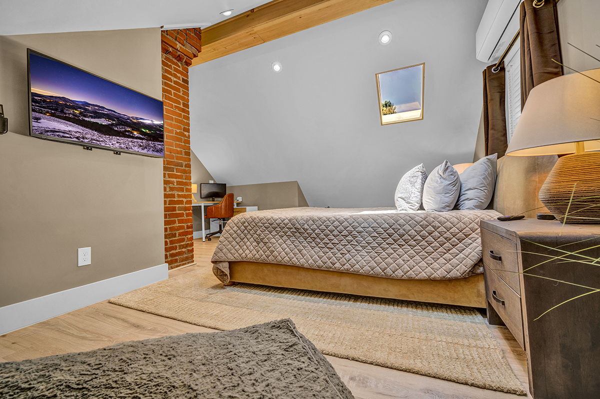 Master Bedroom with King Bed, 42-inch Smart TV, Fireplace, sound machine, blackout curtains and cozy reading chair