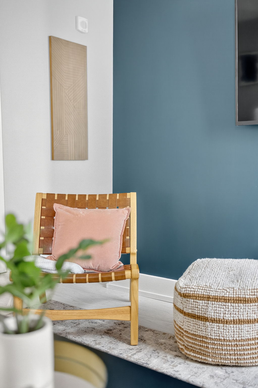 Mid-century details meet modern comfort—accented by warm woods, soft textures, and pops of blush.