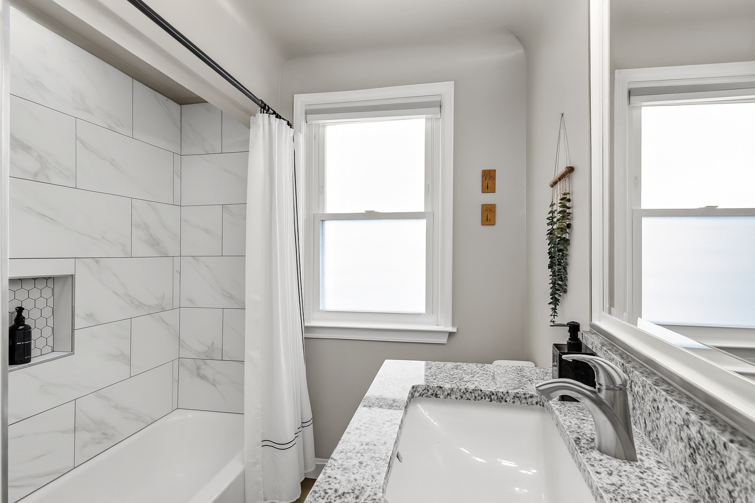 Bathroom features spacious bathtub and luxurious finishes