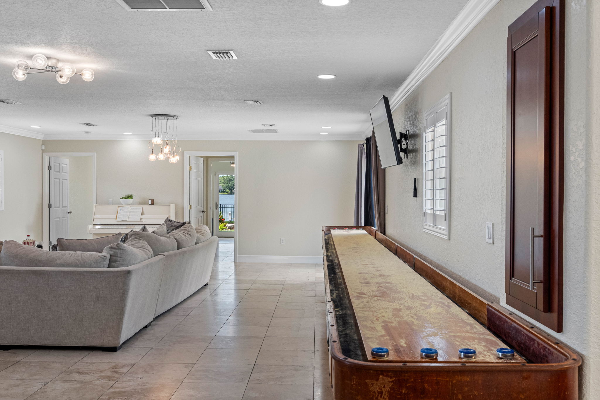 Enjoy a friendly match on the shuffleboard table while catching a game or show on the wall-mounted TV.