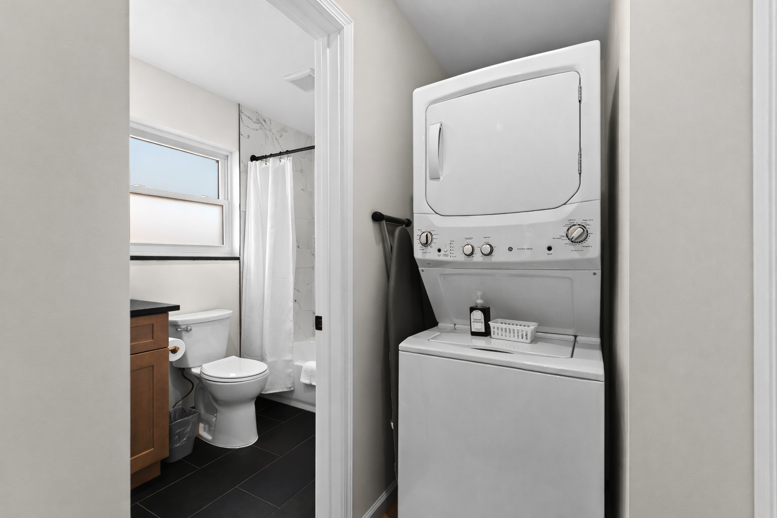 Convenient in-unit laundry tucked beside the bathroom—making longer stays easy, comfortable, and stress-free.
