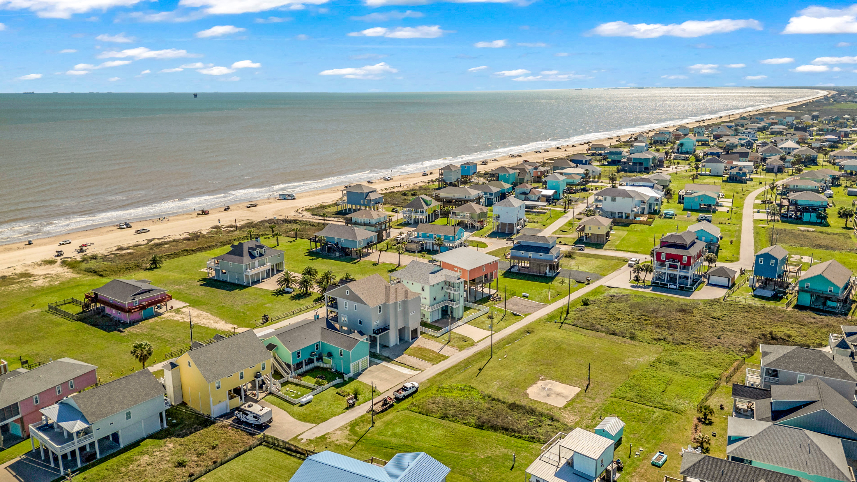 Costa Cristal Exterior: Aerial view of the beautiful coastal neighborhood with spacious homes, open skies, and easy access to the shore.