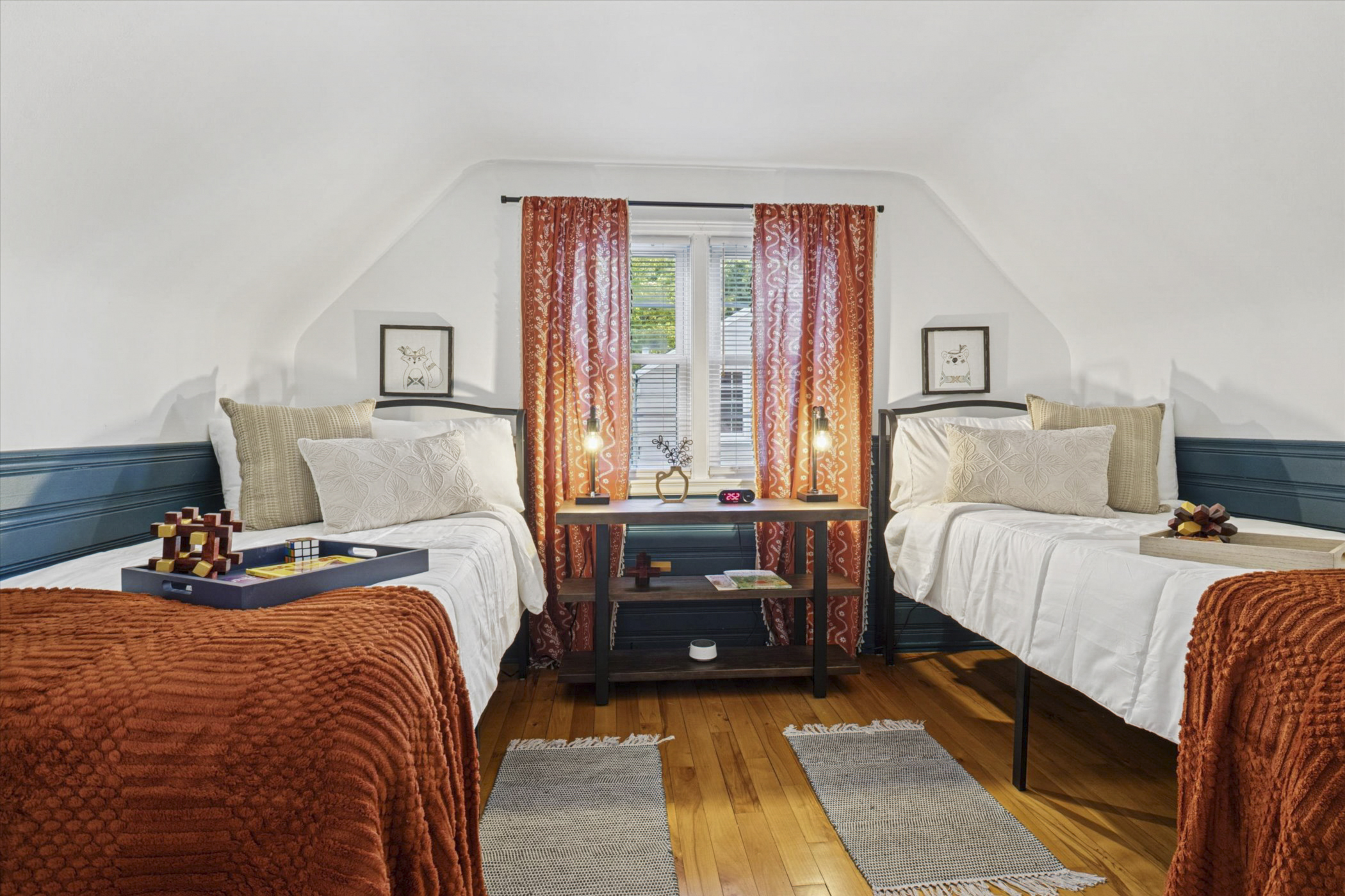 Twin XL beds with white noise machine, bedside chargers, alarm clock, and wall-mounted TV offer restful sleep. A safety rail and step stool add peace of mind at our South Bend guest retreat.