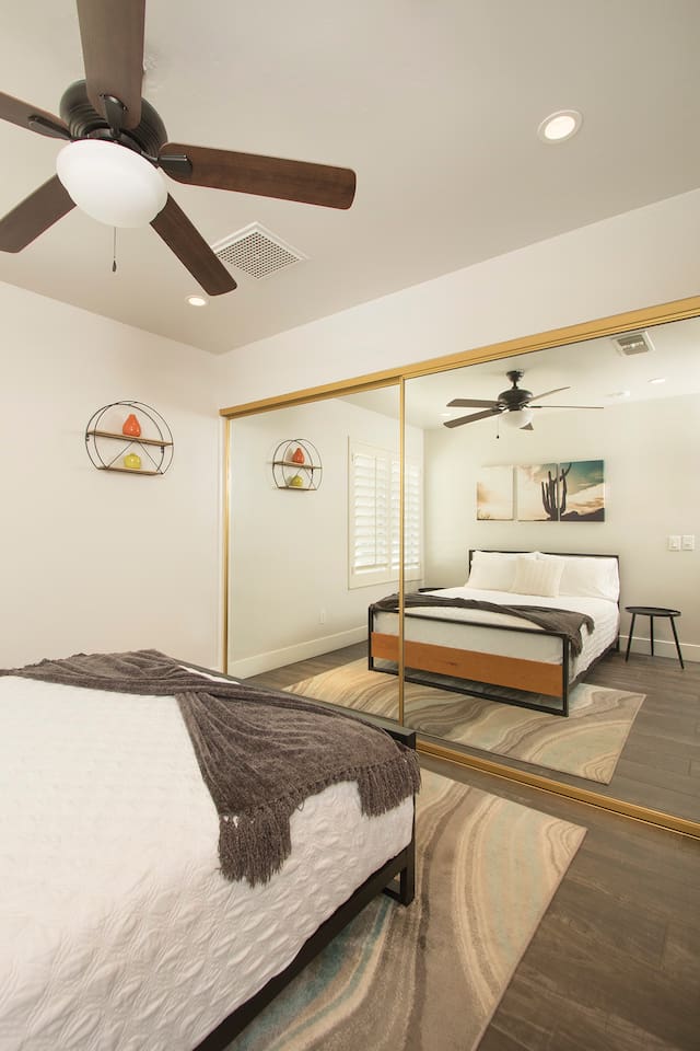 2nd bedroom with queen bed and full body length mirror