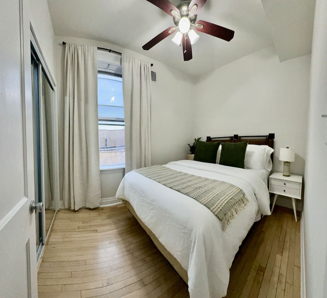 Bright guest bedroom with soft linens and relaxing decor.